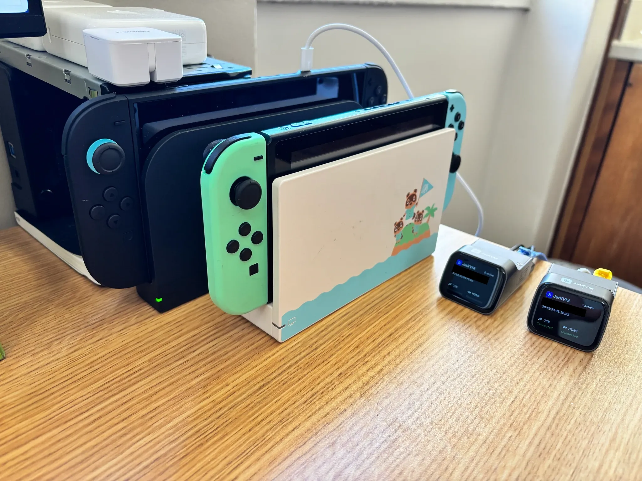 a Switch 1 and 2, two jetkvms, and a switchbot